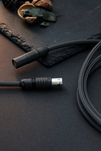 Dark grey coiled USB-C keyboard cable with push-pull cable 